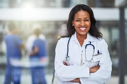 A doctor with a stethoscope smiling